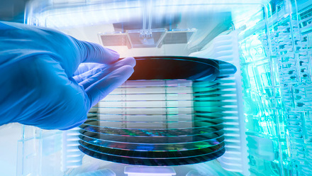 Gloved Hand Holding a Silicon Wafer iStock-1956523068.jpg