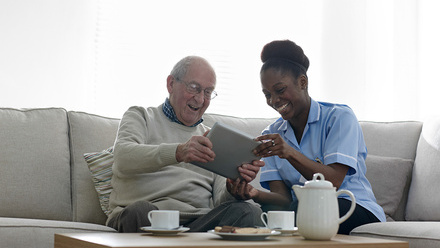 Health and social care -Happy senior man and nurse using digital tablet iStock-532206461_resized.jpg