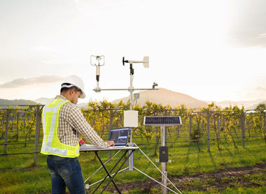 Man with tech in field  CLIMATE CAMPAIGN ONLY.jpg